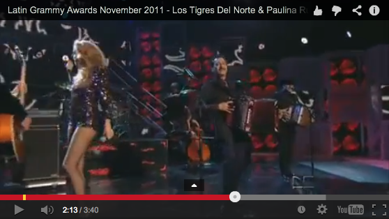 Los Tigres Del Norte perform with Paulina Rubio at the 2011 Latin Grammy Awards.